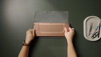 While sandwiching the board, carefully flip it over.