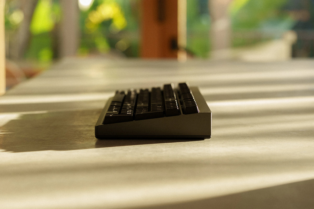 Side profile of a Mode Prologue in Black Sesame on a sunlit concrete table